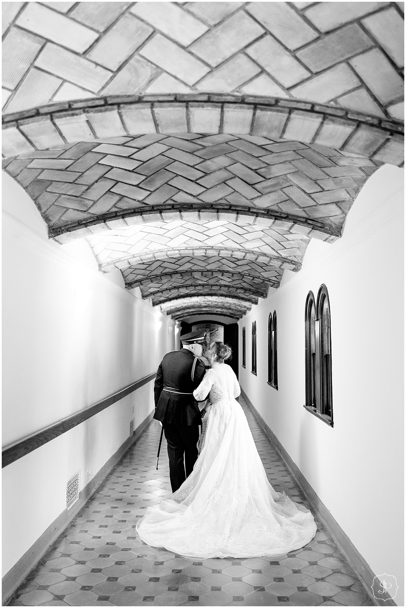 Bride and groom kidding in a long hallway